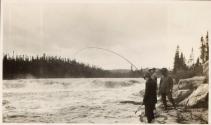 Companions fishing on riverbank, Labrador Trip