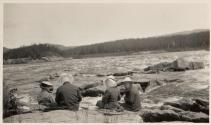Companions picnicing on riverbank, Labrador Trip