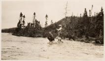 Companion fishing on riverbank, Labrador Trip