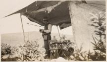 Man with camera in tent, Labrador Trip