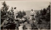 Men with wood at campsite, Labrador Trip