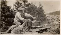 Charles Newhall cooking outdoors, Labrador Trip