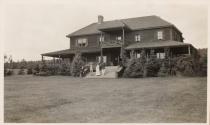 People on steps of large house, Labrador Trip
