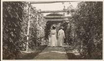 Women strolling under pergola, Labrador Trip