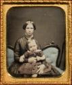[Woman holding baby girl]