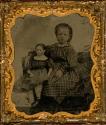 [Seated girl with large doll]