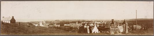 [Panoramic town view from hilltop]