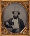 [Man holding a dog]