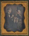 [Two men eating watermelon]
