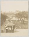 [Newspaper stand in formal garden]