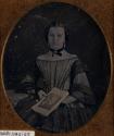 [Portrait of a woman holding picture]