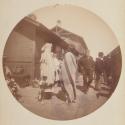 [Two men wrapped in blankets on railroad platform]