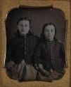 [Portrait of two girls in buttoned shirts]