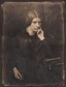[Woman with hand on face]