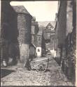 [Man sitting on cart in a close]