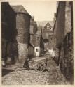 [Man sitting on cart in a close]