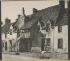 [Woman standing in doorway of building]