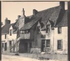 [Woman standing in doorway of building]