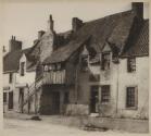[Woman standing in doorway of building]