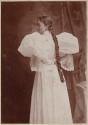 [Woman with long braid and large sleeves]