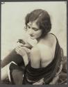 [Ruth Malcomson, third Miss America, holding tube with back exposed]