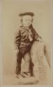 [Boy standing on chair]