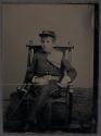 [Seated boy in military uniform]