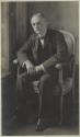 Portrait of George Eastman sitting in chair