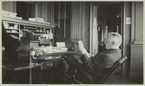 George Eastman reclining at his desk at Eastman Kodak Company