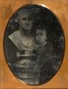 Youth adoring a bust of George Washington.