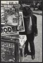 [Man at newsstand]