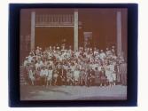 [Large group portrait in front of building]