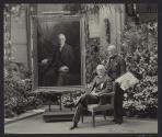 George Eastman and Philip De Laszlo beside portrait in Conservatory