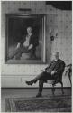George Eastman seated beside his portrait