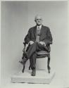 George Eastman seated in chair