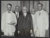 George Eastman posing with officials involved in calendar reform