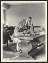 Charles H. Goulding (seated), managing director of the Eastman Theatre and Arthur Amni (standing), house manager