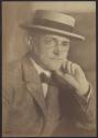 George Eastman in straw hat