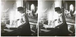 [Woman looking at photo album]