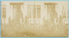 [Workers in front of building doorway]