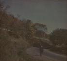 [Man walking along road]