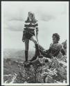 Couple resting on mountain climb