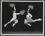 Two cheerleaders in air