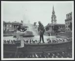 Man getting Ektasound movie camera footage of woman beside London fountain