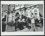 Man photographing woman and Roman horses with Kodak Pocket Instamatic Camera