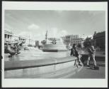 Man getting footage of woman beside fountain