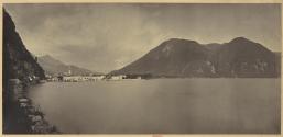 [Town at end of lake, mountains in background]