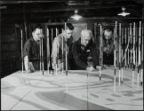 Geologists study peg model, North West Territories, Canada