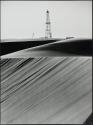 Oil well drilling rig by sand dunes, Sharqīyah, Saudi Arabia