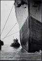 Tug boats pushing Esso Zurich to docks, New York Harbor, New York